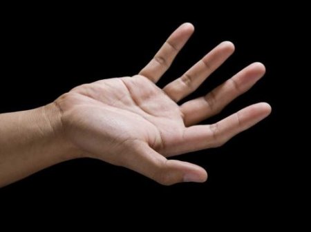 open-hand-against-black-background